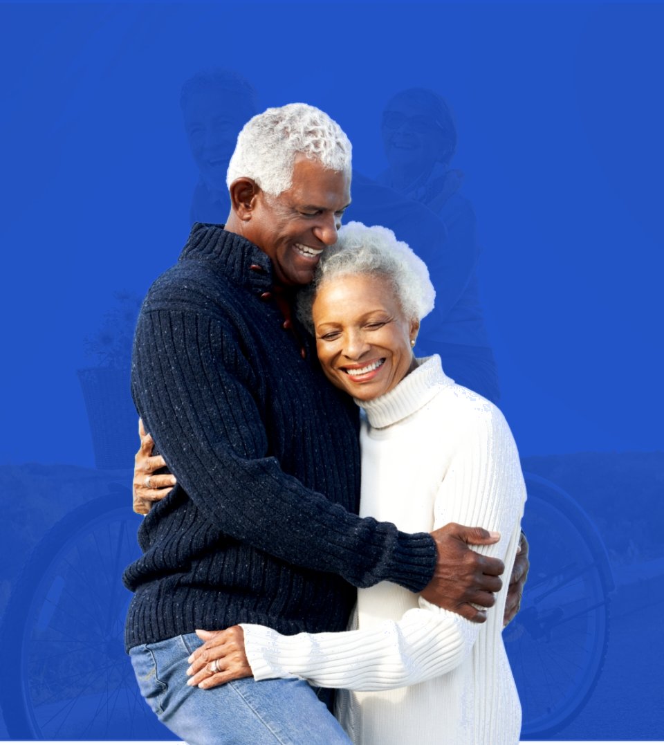 A smiling senior couple embracing, on a bright cyan background